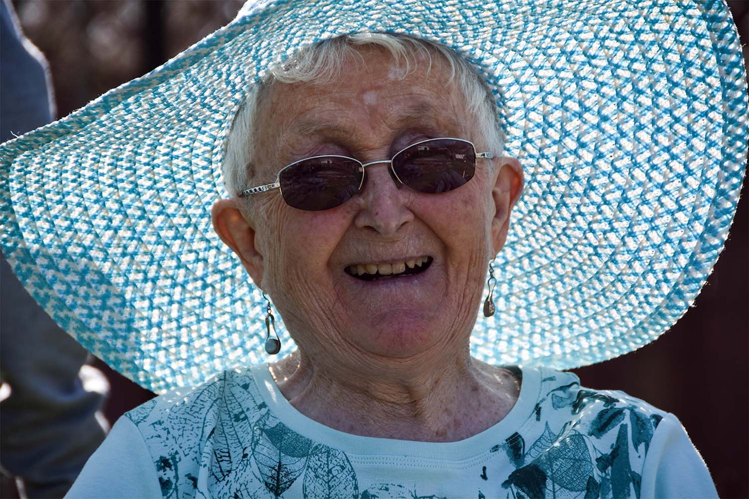 resident smiling with a hat on