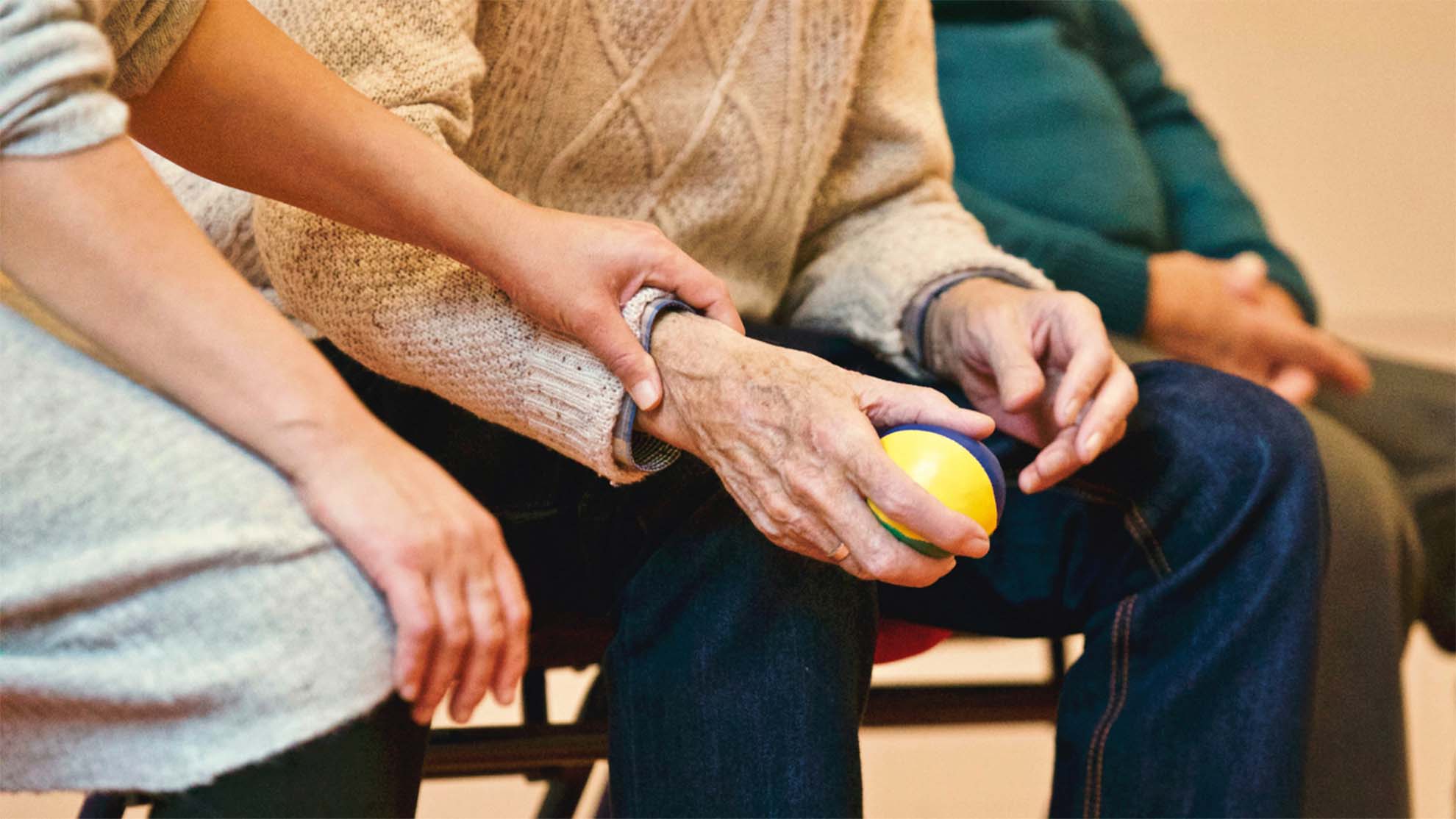 carer holding a residents hand