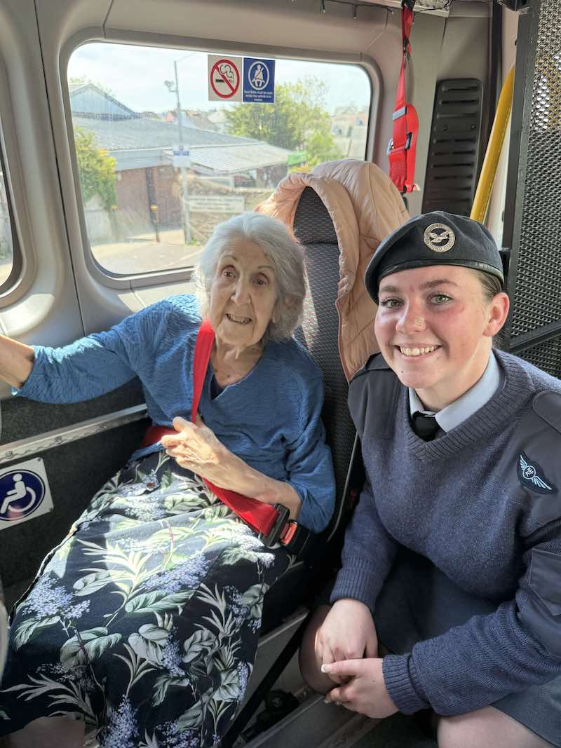 resident sat on minibus with forces member