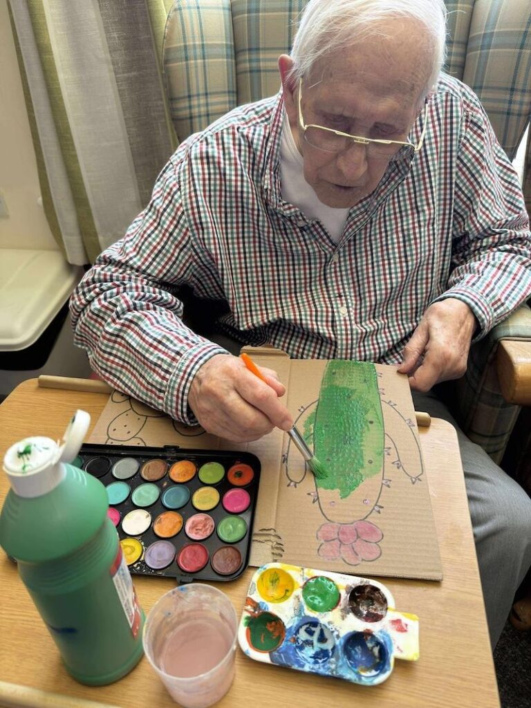 resident sat down painting a cactus