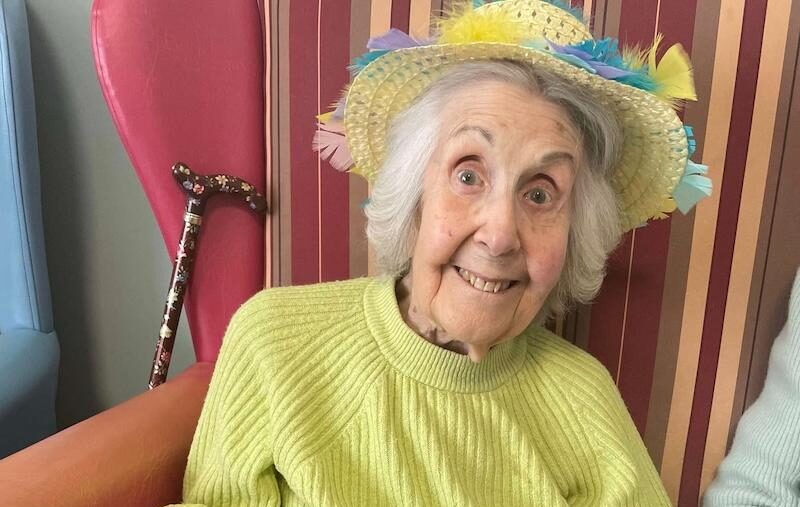 resident smiling with some easter nests in her hand