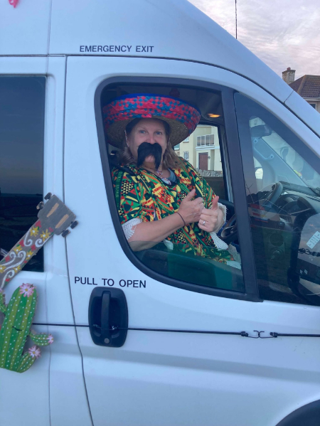 Minibus driver at the check house dressed as a mexican