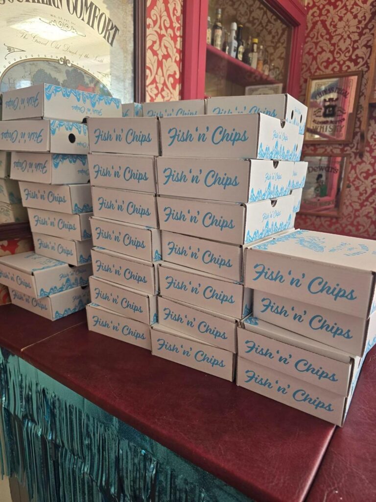 a stack of fish and chips boxes