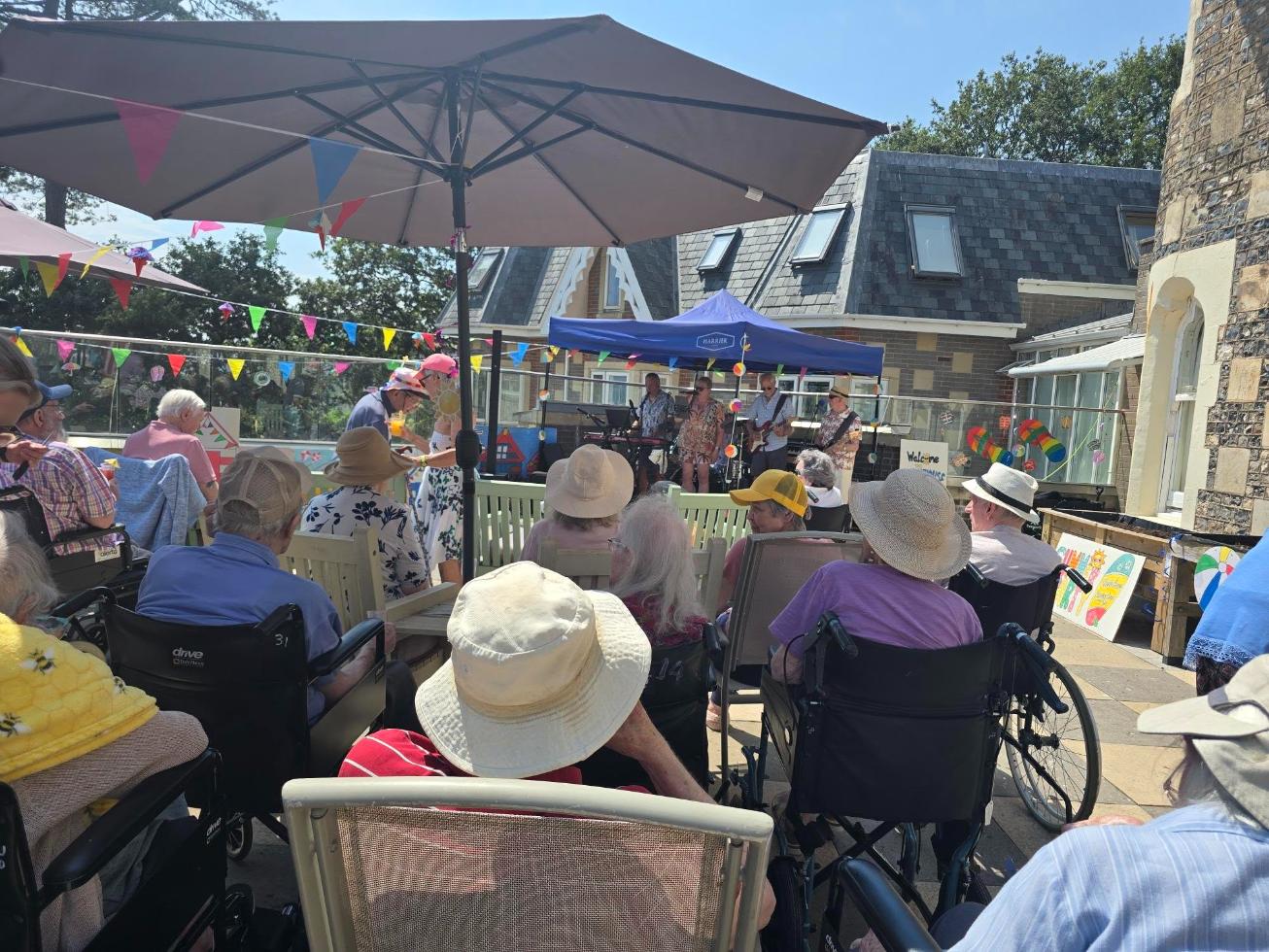 residents in a garden listening to music